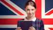 Pretty young girl holding in hands exercise book over british flag background, language, english, Learning and study concept,