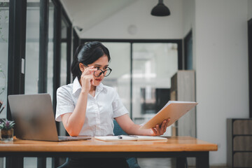 Wall Mural - Attractive mature businesswoman working on laptop in office room