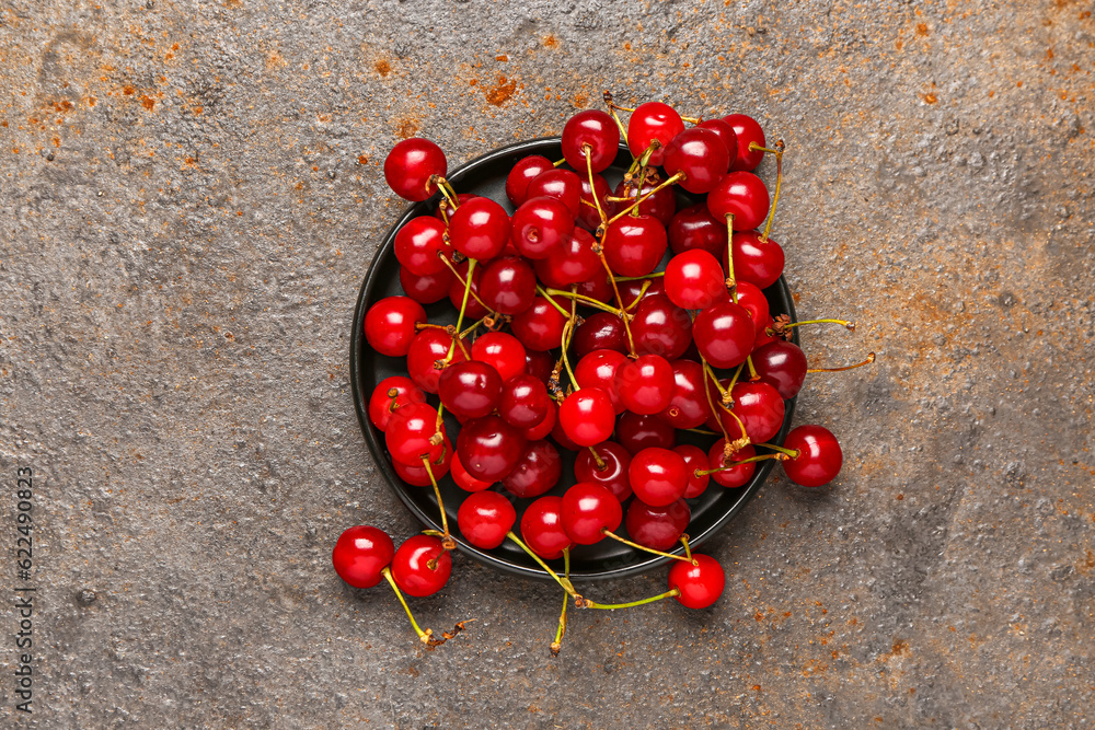 Tray with red sweet cherries on dark background