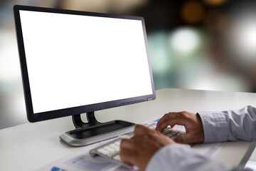 Wall Mural - a young businessman is working on the laptop using a desktop computer with a blank screen and an emp