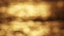 Blurred Orange Sea At Sunset Or Sunrise Sky Over Sea Surface. Silhouette Of Waves Bokeh Light Beautiful Nature Background.Slow Motion Video Waves Background