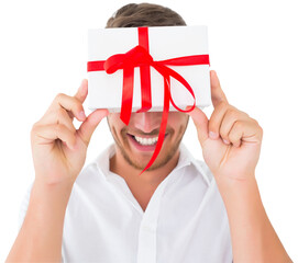 Sticker - Digital png photo of caucasian man holding box with red ribbon on transparent background