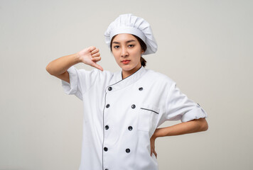 Wall Mural - Irritable angry emotional Unhappy annoyed Young beautiful asian woman chef in uniform on isolated background. Cooking woman Occupation chef or baker People in kitchen restaurant and hotel.