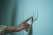 © Chanakon - Earth Hour Close up woman finger turn off or on the light to saving electrical energy. Finger pushing light switch turn on or off. White switch