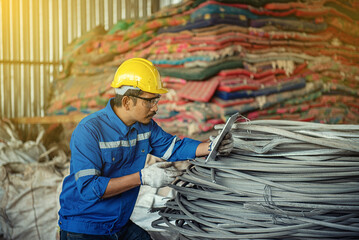 Wall Mural - Professional Industrial Mechanical Engineer with Factory Worker. Technological process plastic bottles at the factory for processing and recycling. The worker recycling factory