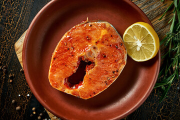 Wall Mural - Marinated salmon steak in a clay plate. Delicious seafood