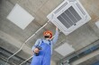 © Serhii - technician service checking and repairing air conditioner indoors