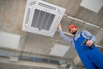 Wall Mural - technician service checking and repairing air conditioner indoors