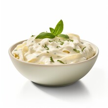 A Delicious Pasta Dish Served In A White Bowl With A Fresh Green Leaf Garnish