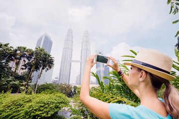 Wall Mural - Woman photographing skyscrapers.