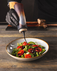 Sticker - Chef pours sauce on the salad dish.