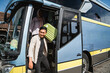 © Odua Images - happy asian muslim passengers lined up in line to get off the bus