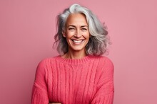 Portrait Of Smiling Mature Woman With Grey Hair Looking At Camera Isolated Over Pink Background