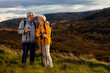 © Zoran Zeremski - Portrait of active senior couple with backpacks hiking together in nature on autumn day.
