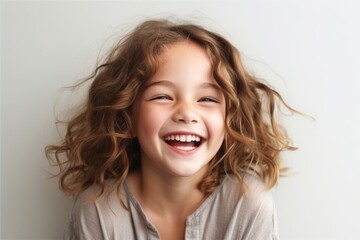 Poster - Happy smiling little girl with long curly hair looking at camera over white background