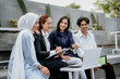 © Odua Images - group of young Asian business people chatting while brainstorming ideas together during an outdoor meeting