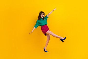 Poster - Full length photo of excited funky woman dressed green shirt walking having fun empty space isolated yellow color background