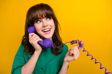 Photo Of Dreamy Girly Lady Wear Green Shirt Speaking Phone Looking Empty Space Isolated Yellow Color Background