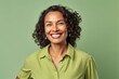 © igolaizola - Portrait of a smiling african american woman on green background