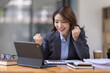 © David - Excited asian woman sit at desk feel euphoric win online lottery, happy asian woman overjoyed get mail at tablet being promoted at work, biracial girl amazed read good news at computer