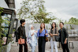 © Odua Images - Asian university students stand up while chatting in an outdoor coworking space