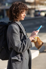 Wall Mural - Young woman commuter using mobile phone on her daily commute