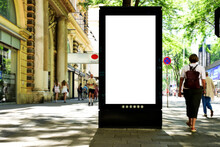 Billboard On Busy Street. Blank White Poster And Advertiser Ad Space. Digital Outdoor Display Lightbox. Base For Mockup. Empty Display Panel. Glass Design. Soft Streetscape. Urban Background