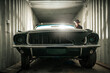 © Tomasz Zajda - Damaged Classic American Muscle Car Inside a Shipping Cargo Container