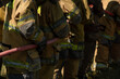 © Chanwit - Firefighters and rescue training. Firefighter spraying high pressure water to fire Burning fire flame background