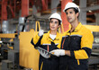 © Nassorn - Latino industrial engineer in white helmet and safety jacket work in heavy metal engineering factory. Technician worker team using tablet computer control metalwork in manufacturing facility, portrait