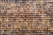 Wood Shake Wall. Wood shake. Grunge cedar tile panel on the exterior wall. Grunge cedar tile panel on the exterior wall. House wall covered with small wooden tiles as a background
