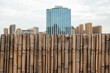 Bamboo fence with city skyline in the background in Chengdu, Sichuan province, China