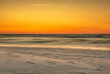 Fototapeta Na ścianę - sunset over the sea, the wind carries the sand