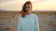 © Keitma - Redhead girl wearing crewneck white sweatshirt standing in the desert