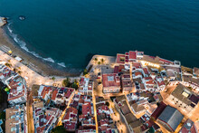 Aerial View Of Sitges Downtown Along The Mediterranean Sea Coastline At Night, Barcelona, Spain.