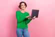 © deagreez - Photo of young optimistic girl wear green pullover hold netbook content maker professional smm manager isolated on pink color background