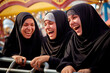 © the_lightwriter - A group of young muslim women wearing headscarves having fun together at the fair