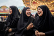 © the_lightwriter - A group of young muslim women wearing headscarves having fun together at the fair