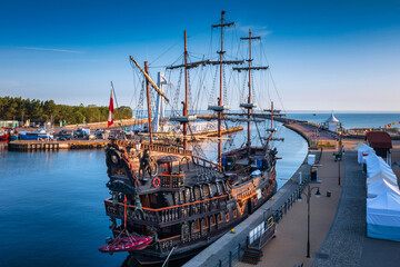 Wall Mural - Pirate ship in Ustka by the Baltic Sea at sunrise, Poland.