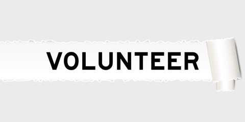 Ripped gray paper background that have word volunteer under torn part