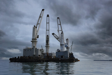 Wall Mural - Marine cranes are used for loading and unloading cargo onto ships.