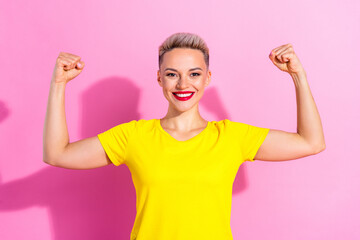 Photo of gorgeous positive person toothy smile hands flexing demonstrate biceps muscle isolated on pink color background
