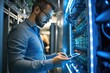 © visoot - Data Center Engineer, Young man holding digital tablet standing by supercomputer server cabinets in data center, Data Protection Network for Cyber Security.