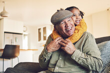 Hug, Grandparent Playing Or Happy Child In Family Home On Sofa With Love Or Care Bonding Together. Piggyback, Living Room Couch Or Senior Grandfather With Young Girl, Smile Or Kid To Relax In House