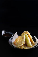 Wall Mural - Mix tempura with shrimp fish and vegetable Japanese food isolated in black background