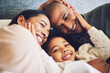 © Azee/peopleimages.com - Home, family and parents relax, quality time and happiness with bonding, peace and loving together. Mother, father and female child with a smile, calm and weekend break with care and kid with support