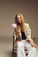 Wall Mural - beautiful woman with natural blond hair in elegant clothes with accessories posing in studio