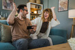 © Miljan Živković - couple man and woman husband wife play smart phone video games at home