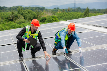 Wall Mural - Technician engineer planning to setting solar panel on the roof of the building to work at full efficiency, Using solar cells for energy saving to save and protect environment. Renewable energy