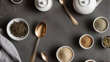 Assortment Of Dry Tea In Spoons On Stone Table